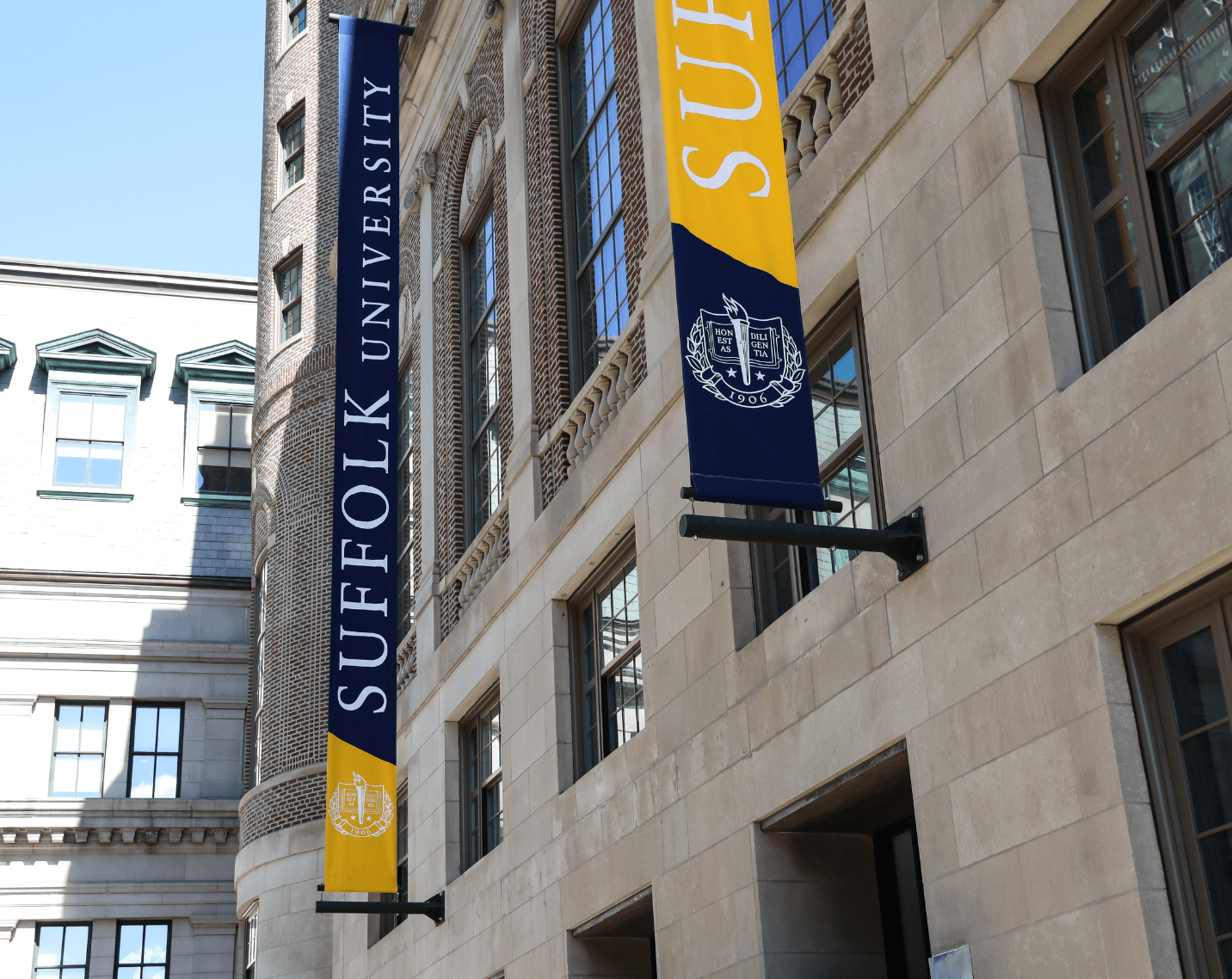 Suffolk University banners on a building. 